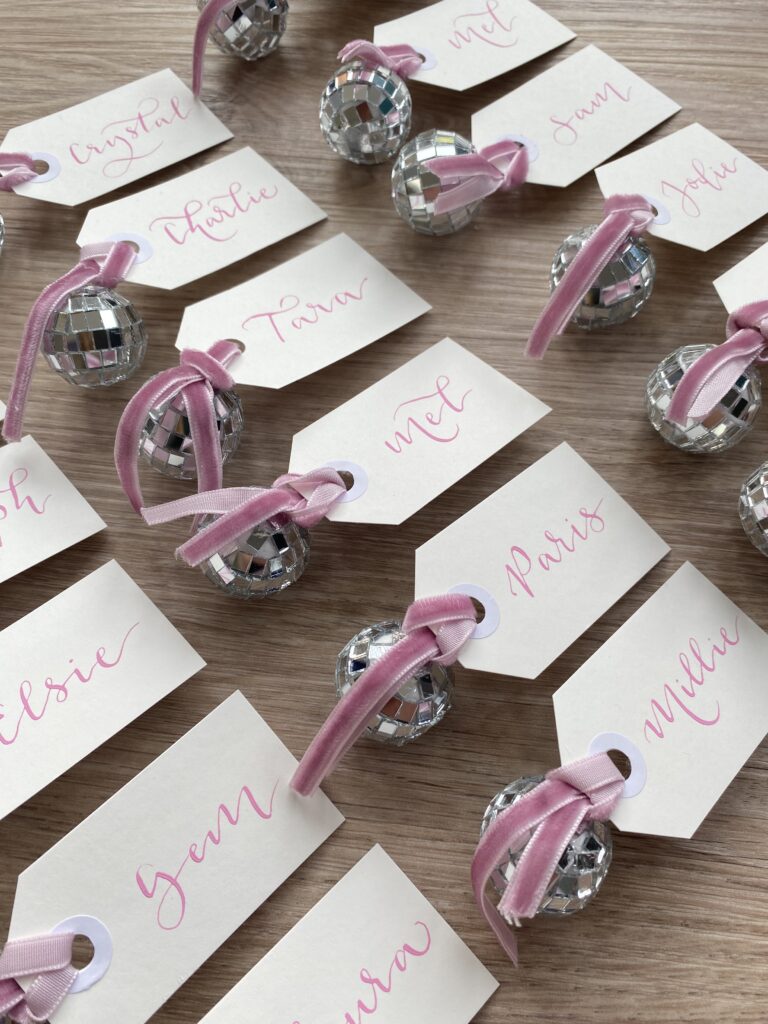 Table place names with disco balls for a wedding