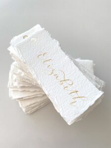 Handmade paper place names with gold ink