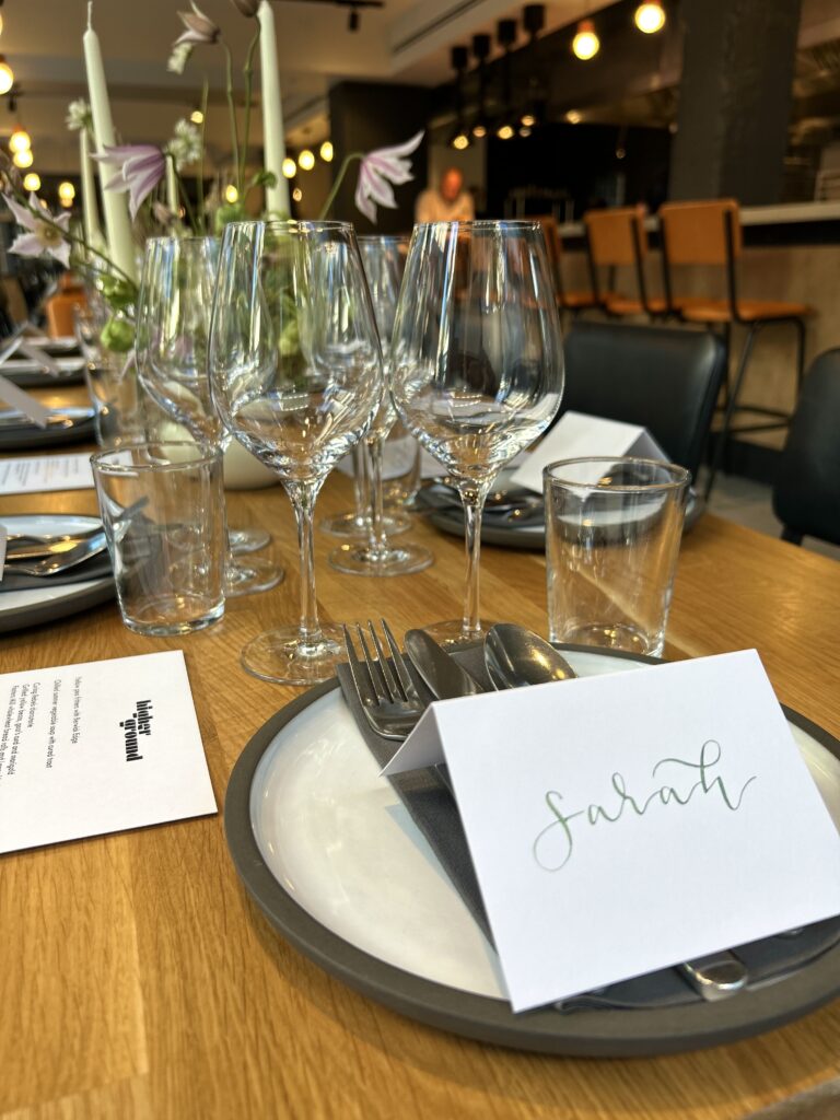 Handwritten place names in metallic green ink for a Selfridges VIP event in Manchester