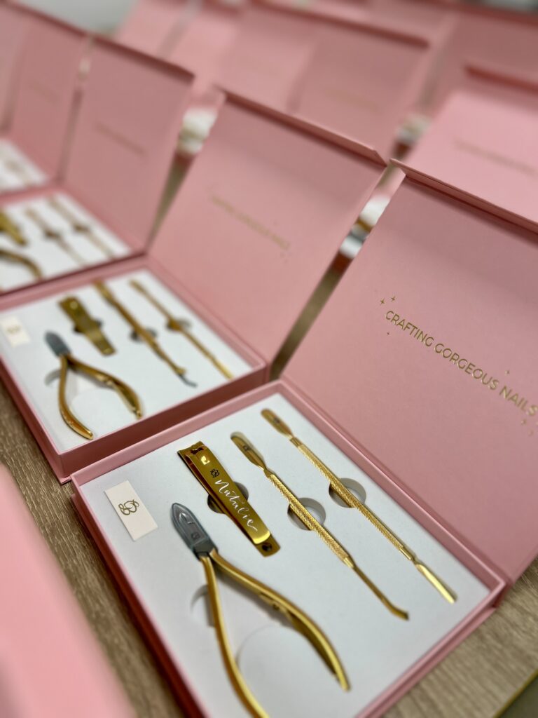 Hand engraving Glitterbels cuticle tool kits at the Stoke warehouse